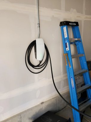 Wall-mounted EV charger installation in a garage in Aurora