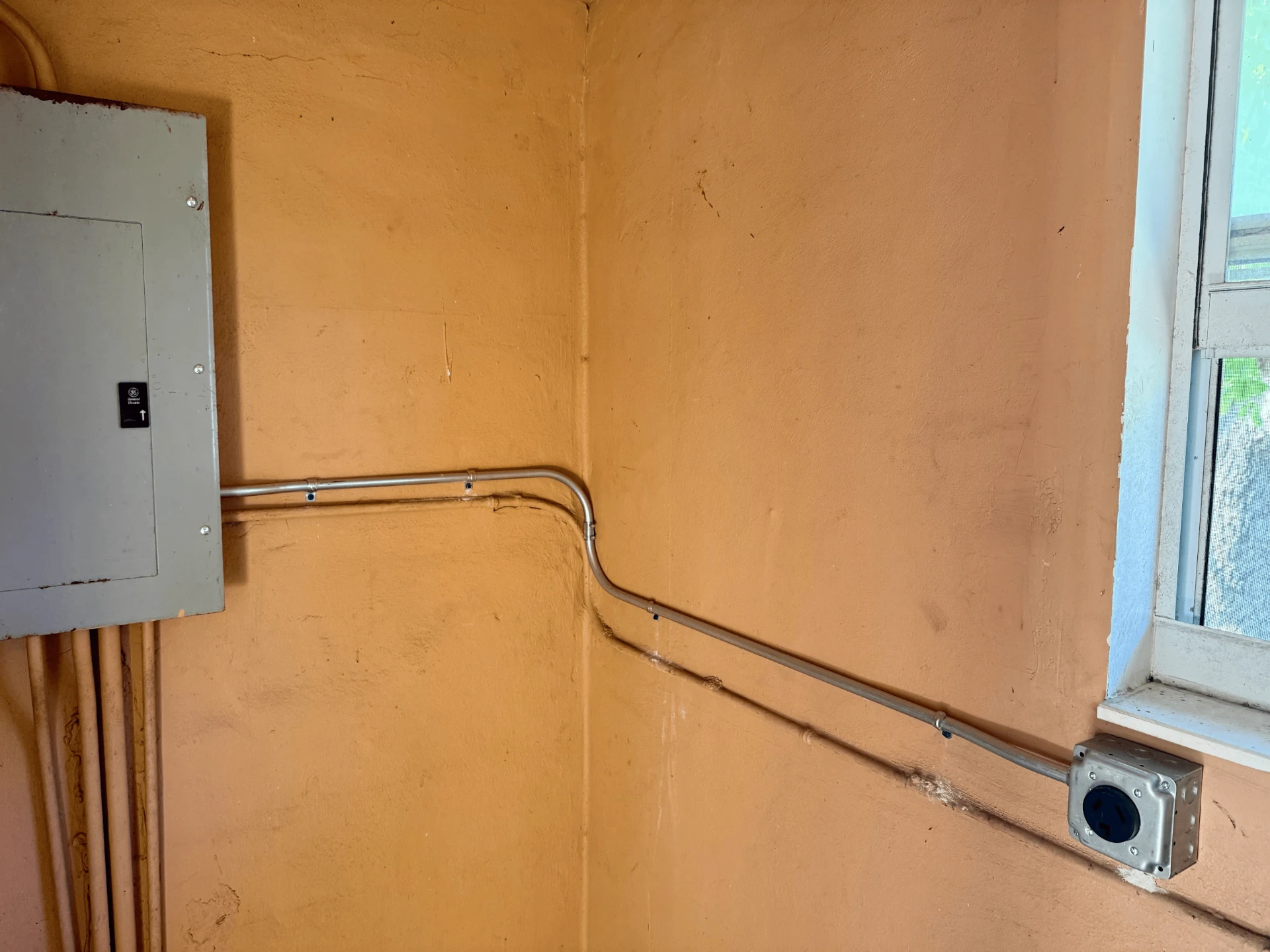 Exterior electrical panel and conduit installation in Aurora